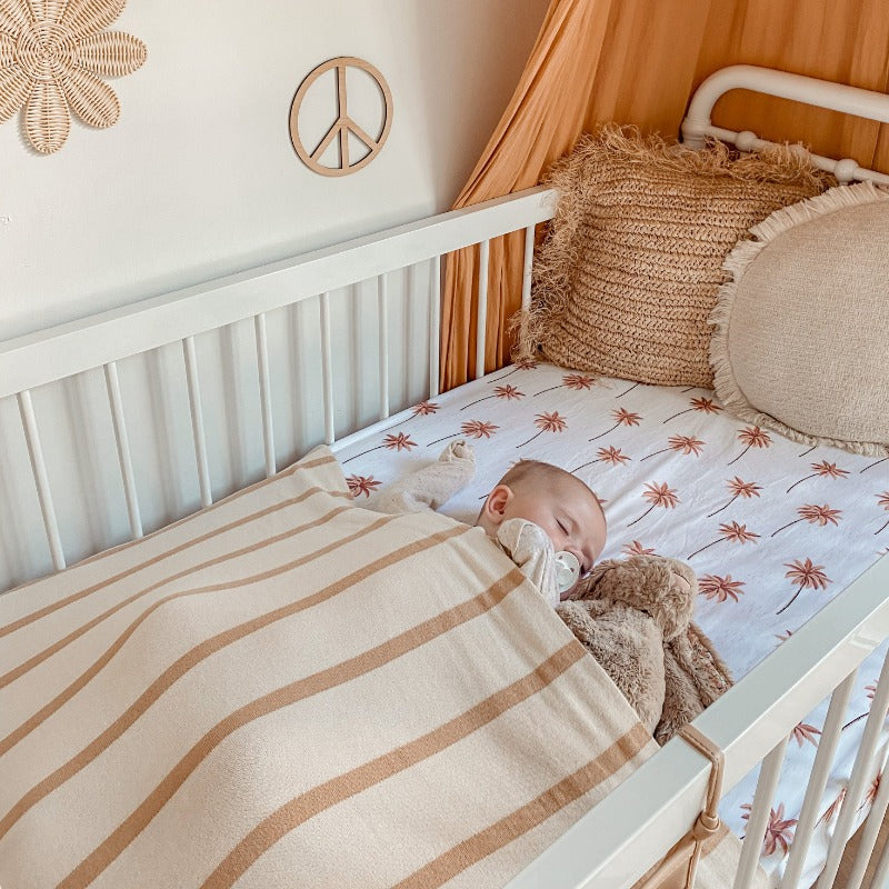 A soft and cozy beige and brown striped cotton knitted blanket by Snuggly Jacks, suitable for baby or nursery