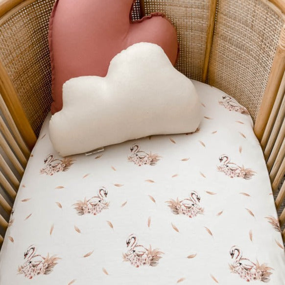 close up shot of a Snuggly Jacks canada bassinet sheet in a rattan bassinet 