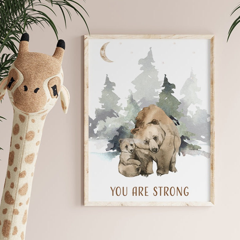 Wooden framed picture of a bear and its cub hanging on a wall in a nursery